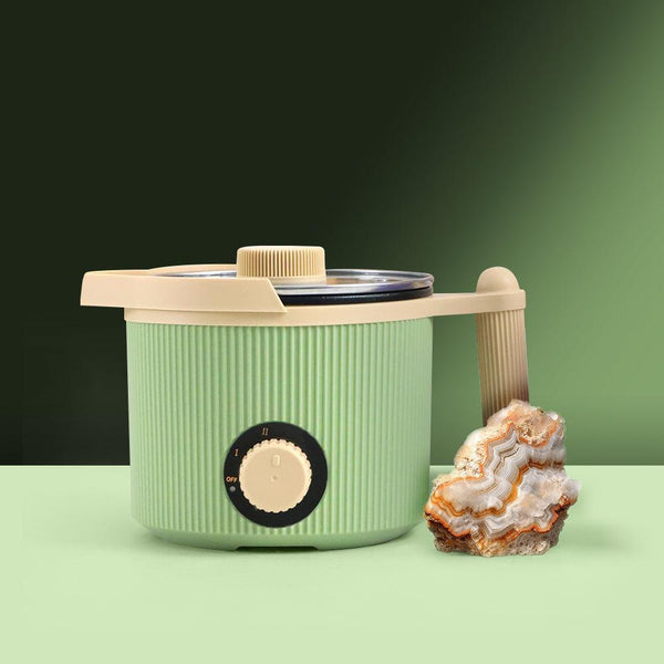 A compact green ToAuto 3LB Wax Melter with a beige lid and handle, alongside a crystal decoration.