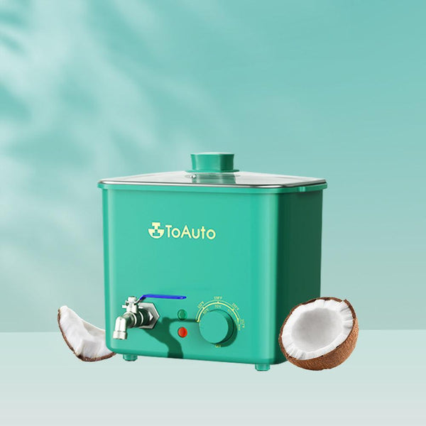 A green ToAuto 8LB wax melter with a faucet and temperature control dial, displayed alongside a coconut and coconut shell.