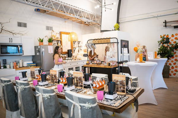 Event setup with tables, chairs, and decorative items in a modern interior.